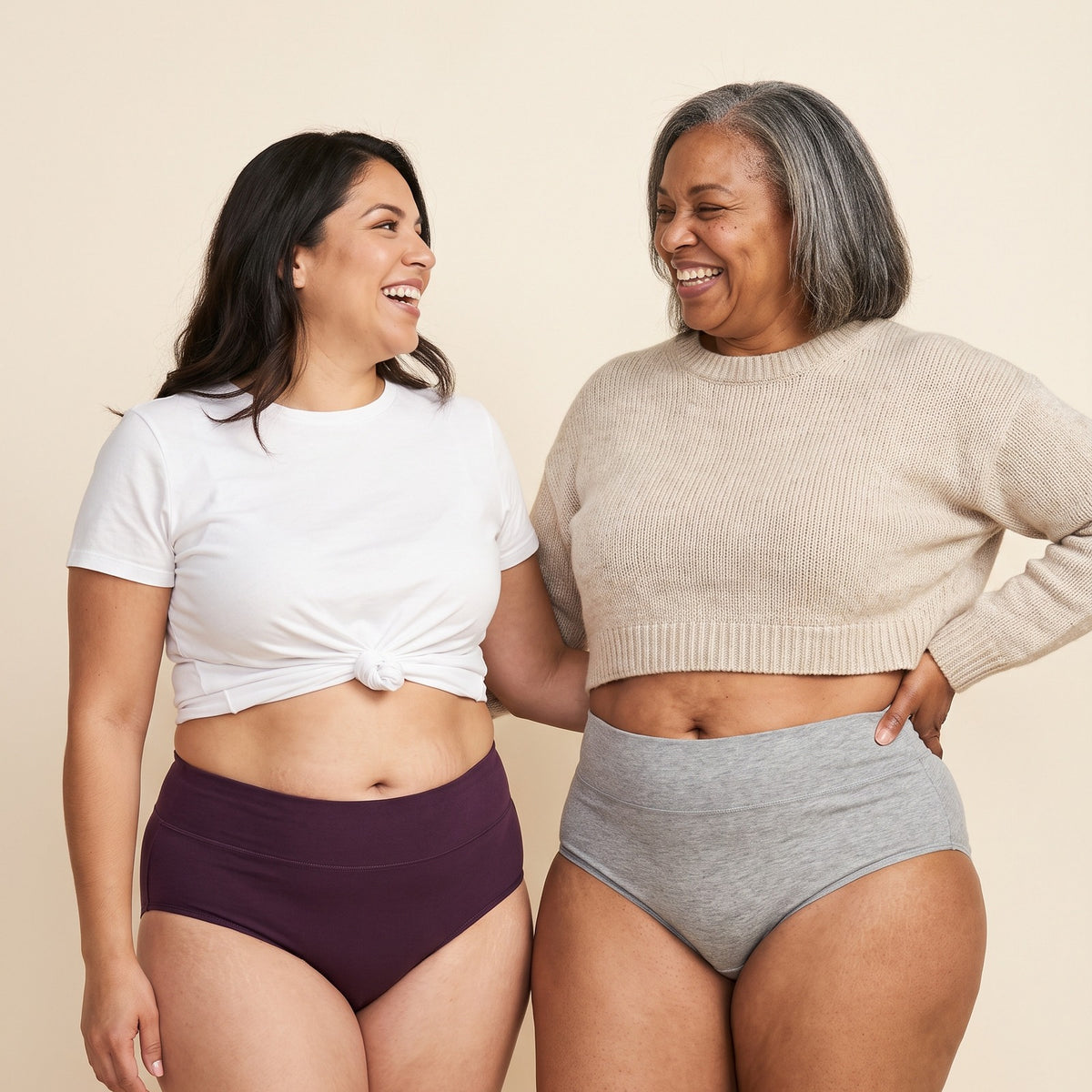Two women laughing in Jadea high-waist cotton briefs, plum and heather gray