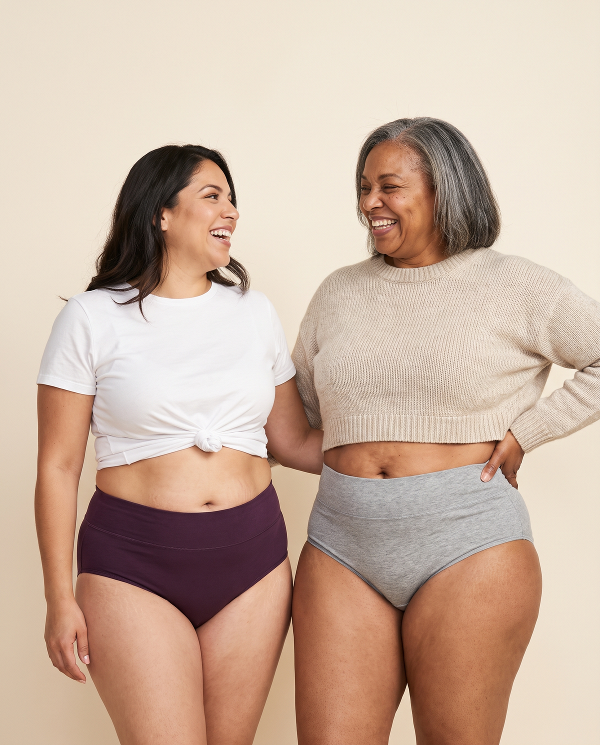 Two women laughing in Jadea high-waist cotton briefs, plum and heather gray