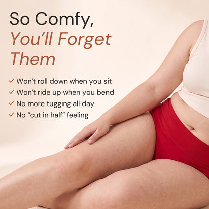 So comfy, you'll forget them: woman sitting on the floor in a red Jadea high-waisted brief. Won't roll down when you sit, won't ride up when you bend, no more tugging all day, no cut in half feeling