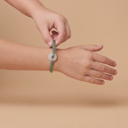 The Jadéa bracelet on a child's wrist, the jade lighting up